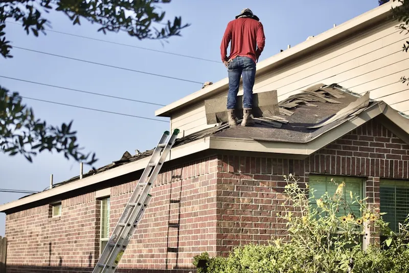 Professional roofer working on a residential roof in Corona